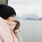 woman keeping warm on a boat