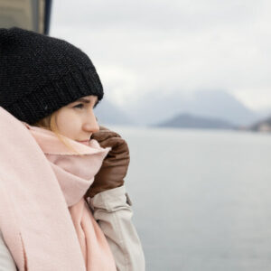 woman keeping warm on a boat