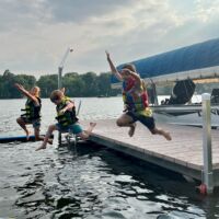 Photo 12 Kids in Life jackets jumping off a VDock