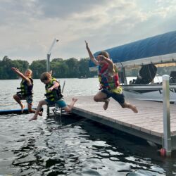 Kids in Life jackets jumping off a VDock
